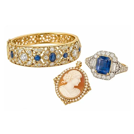 Vintage estate jewelry: a gold bangle set with sapphires and diamonds, a cameo pendant framed in pearls and a sapphire and diamond ring